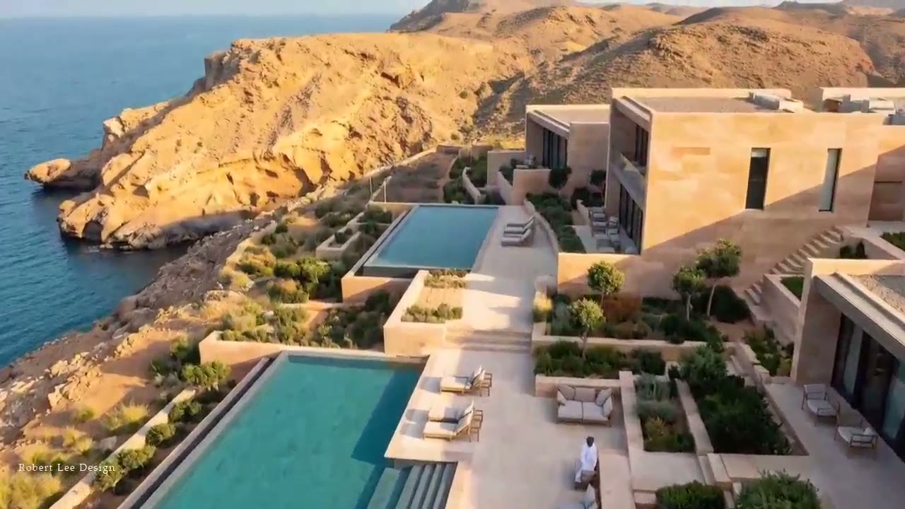 Private Resort, Oman: sandstone villas and stepped infinity pools terraced down a rocky cliff above the sea
